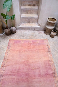 Handwoven vintage Moroccan rug with a beautiful palette of peach and pink