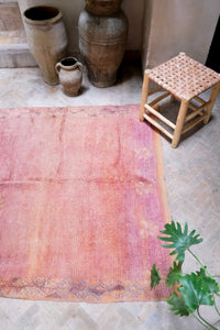 Handwoven vintage Moroccan rug with a beautiful palette of peach and pink