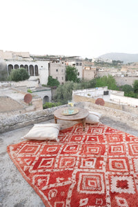 Authentic vintage Moroccan rug low pile cherry red with white colored tribal motifs