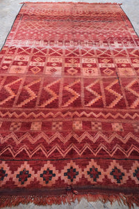 Authentic vintage Zemmour Moroccan rug in a rich raspberry color packed with many intricate motifs 